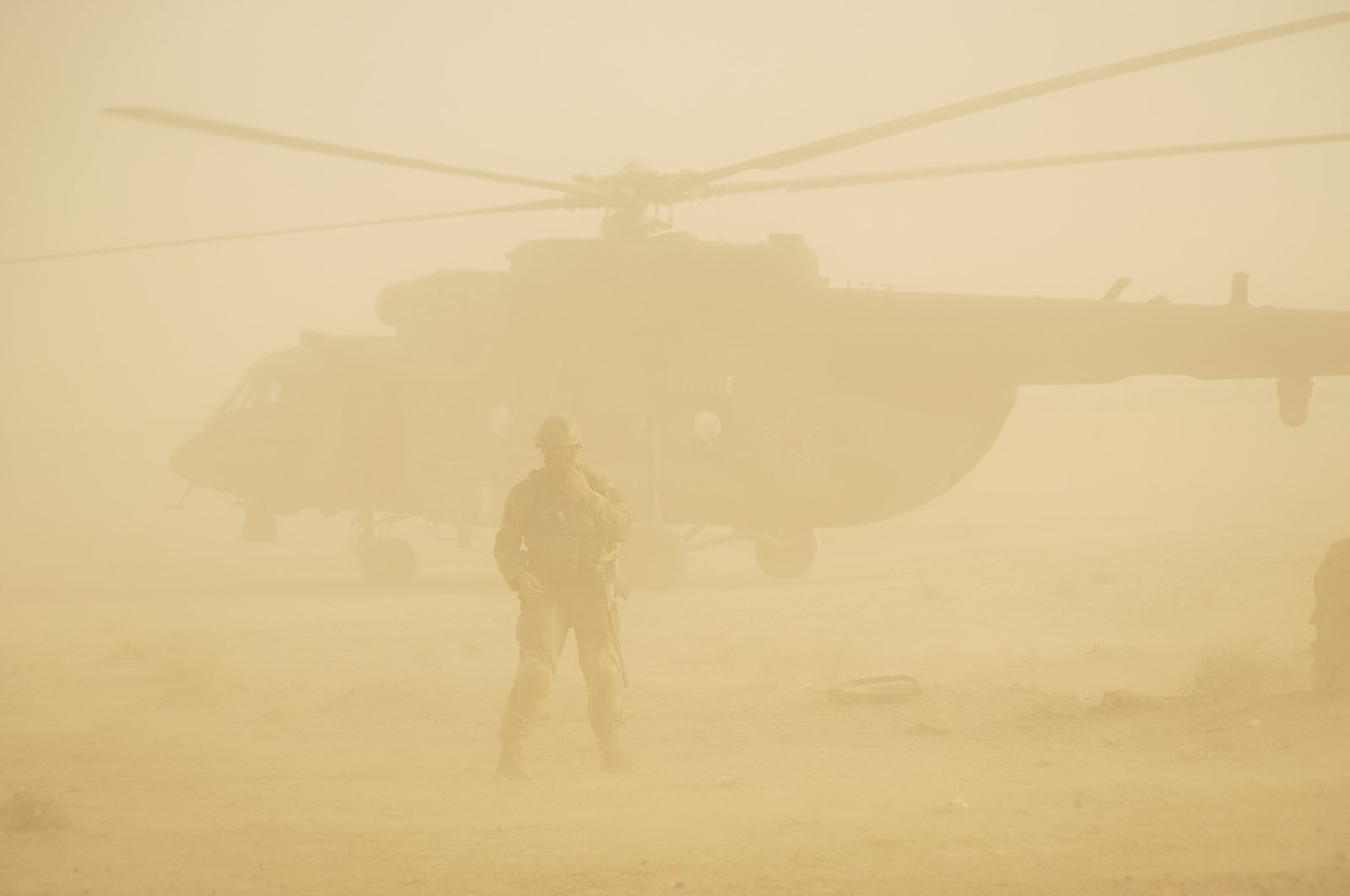 A helicopter is seen amid a dust storm at an airport in Deir eI-Zour, Syria, Sept. 15, 2017. (AP File Photo)