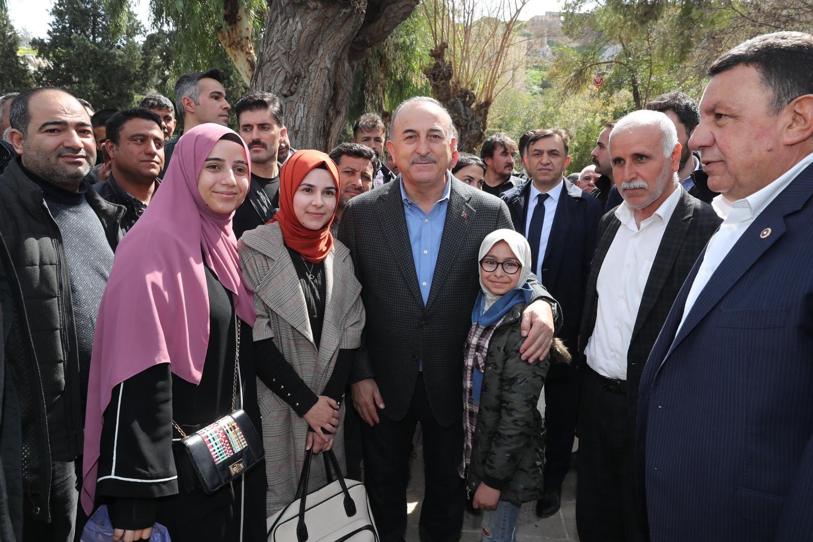 Foreign Minister Mevlüt Çavuşoğlu poses with people near Balıklıgöl Lake after the recent floods in the region, Şanlıurfa, Türkiye, March 27, 2023. (DHA Photo)