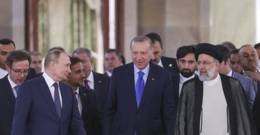 President Recep Tayyip Erdoğan (C), Iranian President Ebrahim Raisi (R) and Russian President Vladimir Putin (L) arriving for a joint news conference after the end of the Astana Trilateral Summit at the Tehran International Conference Hall in Tehran, Iran, July 19, 2022. (AFP Photo)