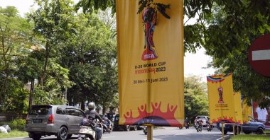 People drive past the banners of FIFA U-20 World Cup 2023 at a main road, Denpasar, Bali, Indonesia, March 27, 2023. (EPA Photo)