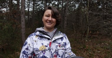 Selime Semra Erol poses holding Cordyceps militaris in Samandıra Forest, Istanbul, Türkiye, March 27, 2023. (AA Photo)