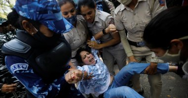 Police officers detain a supporter of India's main opposition Congress party during a protest, New Delhi, India, March 27, 2023. (Reuters Photo)