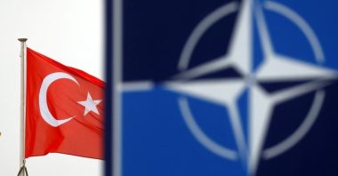 A Turkish flag flies next to the NATO logo at the Alliance headquarters in Brussels, Belgium, Nov. 26, 2019. (Reuters Photo)