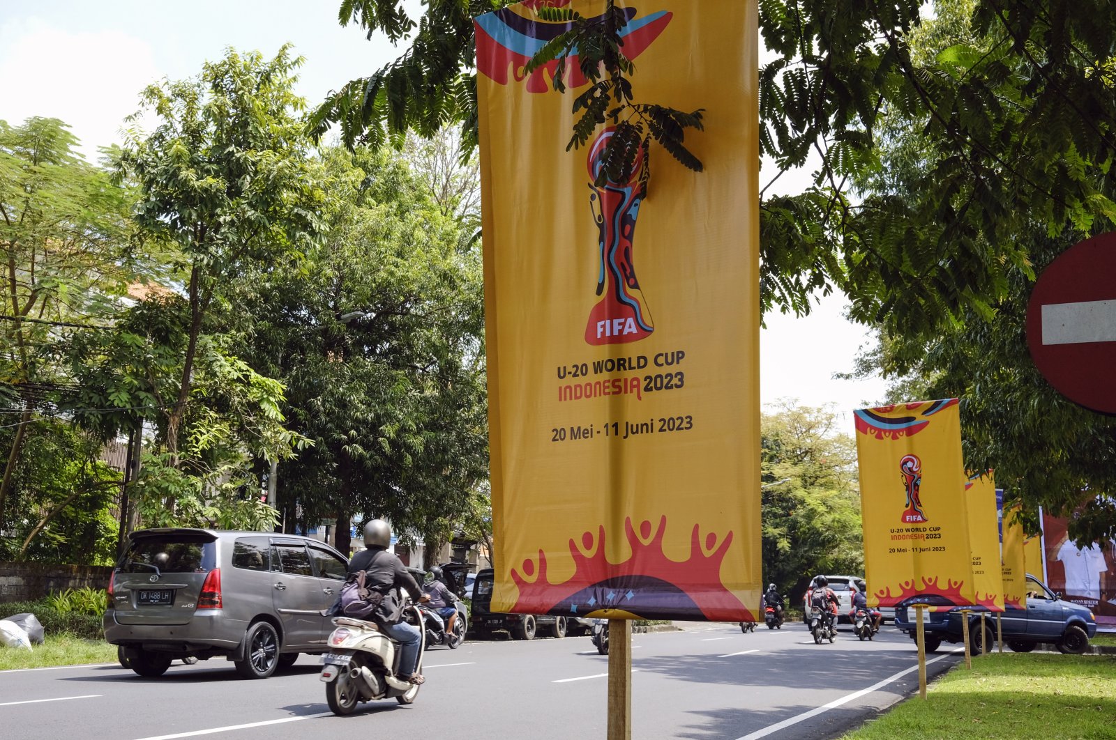 People drive past the banners of FIFA U-20 World Cup 2023 at a main road, Denpasar, Bali, Indonesia, March 27, 2023. (EPA Photo)