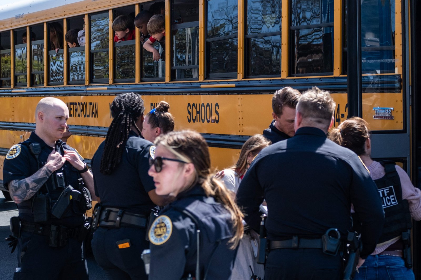 School buses with children arrive at Woodmont Baptist Church to be reunited with their families after a mass shooting at The Covenant School in Nashville, Tennessee on March 27, 2023. (AFP Photo)