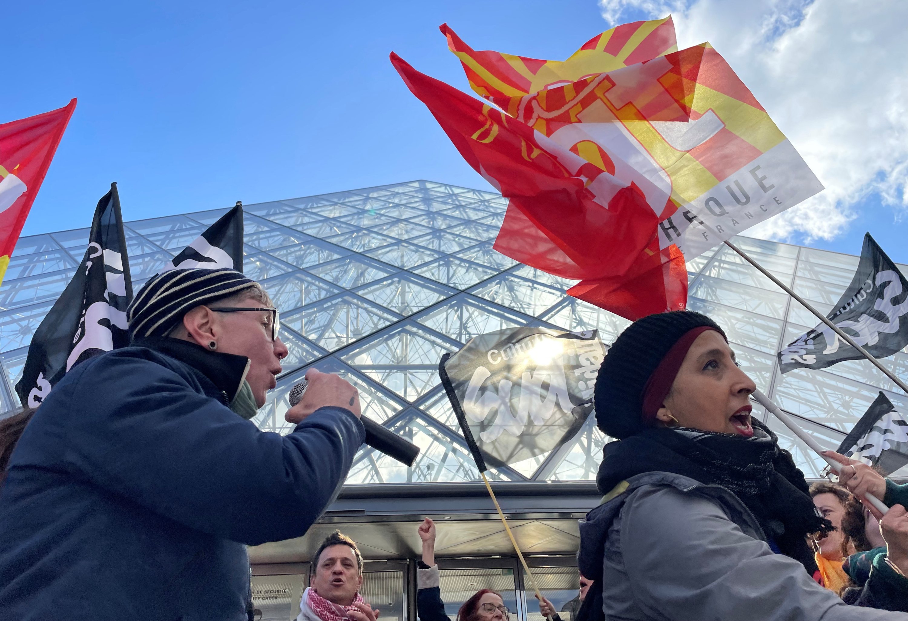 Protesters holding stand in front of the glass Pyramid to block the entrance of the Louvre museum, Paris, France, March 27, 2023. (Reuters Photo)