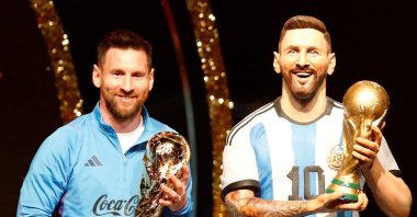 Argentina's Lionel Messi poses with a statue of himself holding the World Cup during the Conmebol event at the Conmebol headquarters, Luque, Paraguay, March 27, 2023. (Reuters Photo)