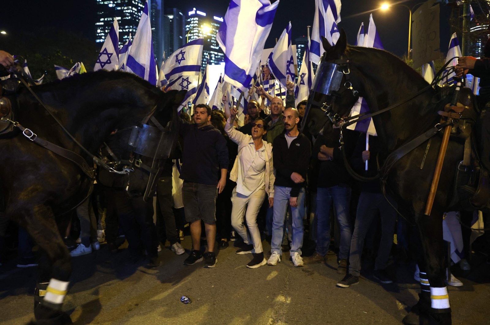 Mounted Israeli police stand guard as protesters attend a gathering in Tel Aviv, Israel, March 27, 2023. (AFP Photo)