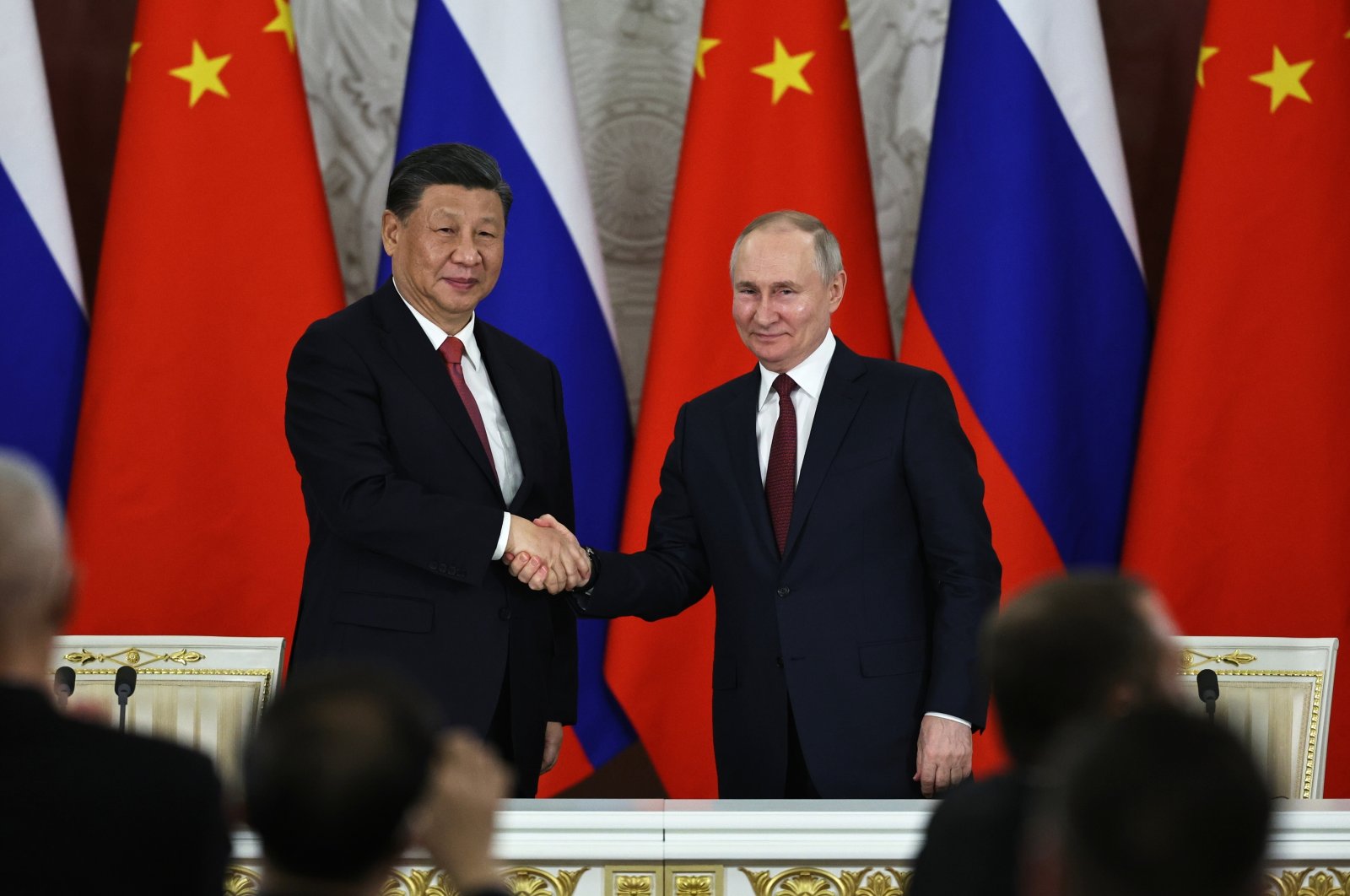Russian President Vladimir Putin (R) and Chinese President Xi Jinping shake hands after speaking to the media during a signing ceremony following their talks at the Grand Kremlin Palace, Moscow, Russia, March 21, 2023. (AP Photo)