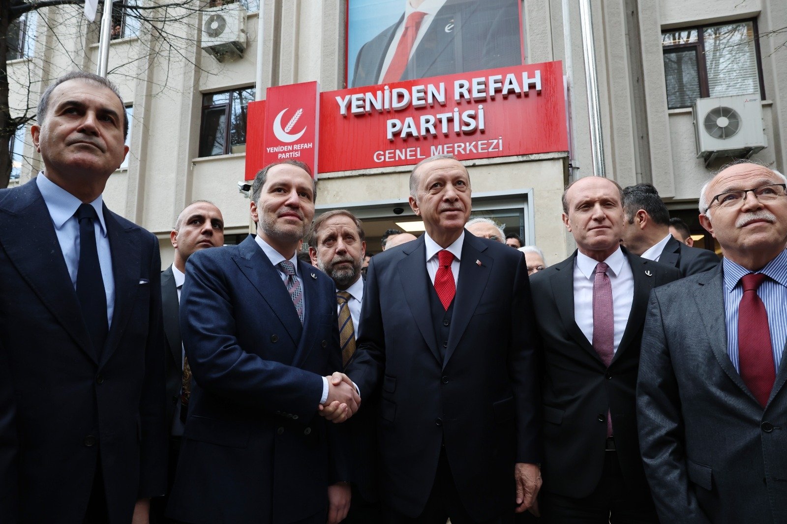 President Recep Tayyip Erdoğan (C-R) is welcomed by the leader of the New Welfare Party (Yeniden Refah Partisi) Fatih Erbakan (C-L) during his visit in Ankara, Türkiye, March 28, 2023. (DHA Photo)
