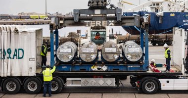 Cylinders of uranium from Russia are loaded onto a transport truck at the port of Dunkirk, northern France, March 20, 2023. (AFP Photo)
