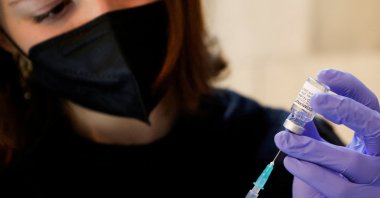 A volunteer prepares a syringe containing a dose of Pfizer-BioNTech COVID-19 vaccine, at a vaccination center in Saint Stephen&#039;s Cathedral, in Vienna, Austria, Feb. 5, 2022. (Reuters Photo)