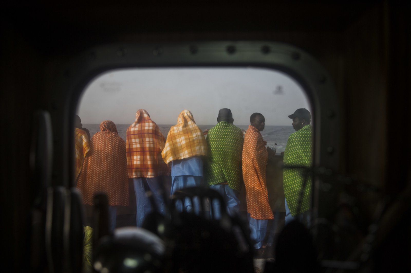 African refugees and migrants, mostly from Sudan and Senegal, look at the sea aboard Golfo Azurro, the Spanish NGO Proactiva Open Arms rescue ship, after being rescued from a boat out of control at 25 miles north of Sabratha, off the Libyan coast, Feb. 23, 2016. (AP Photo)