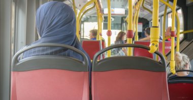 A Muslim in a headscarf rides a bus in Vienna, Austria, Aug. .8 2017. (Shutterstock Photo)