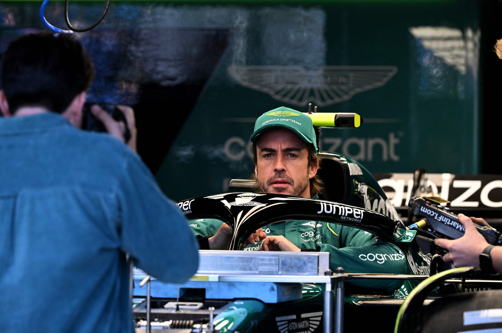 Aston Martin&#039;s Spanish driver Fernando Alonso sits in his car ahead of the 2023 Formula One Australian Grand Prix at the Albert Park Circuit, Melbourne, Australia, March 30, 2023. (AFP Photo)