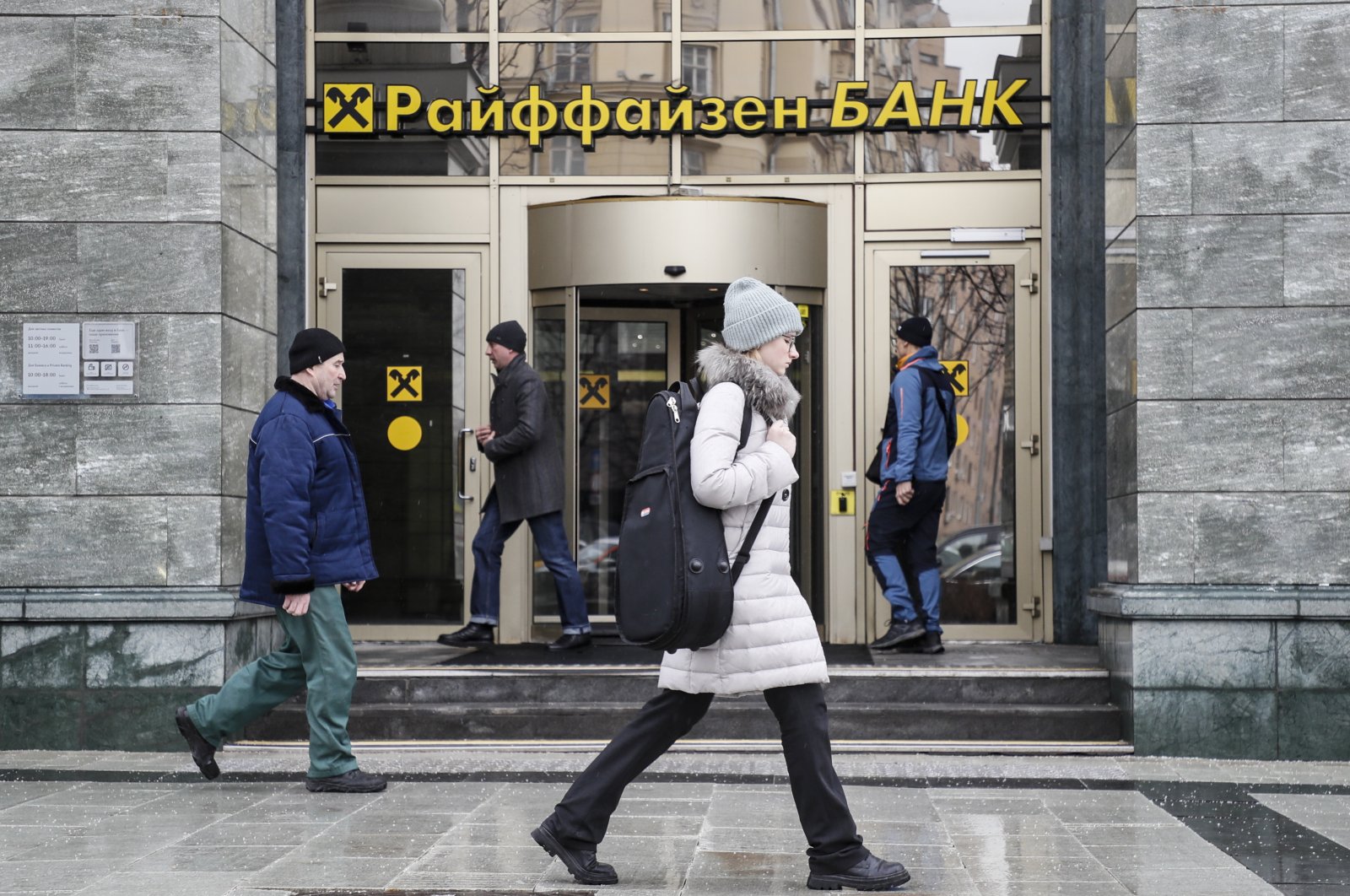 People walk in front of Raiffeisen bank in Moscow, Russia, March 16, 2023. (EPA Photo)