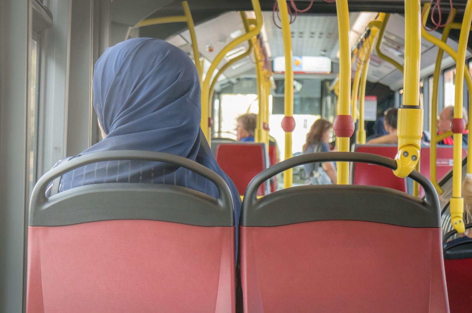 A Muslim in a headscarf rides a bus in Vienna, Austria, Aug. .8 2017. (Shutterstock Photo)