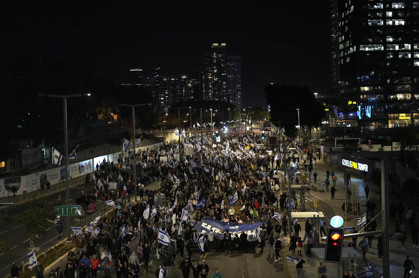 Right-wing Israelis march on a main road as they rally in support of Prime Minister Benjamin Netanyahu&#039;s government plans to overhaul the judicial system, in Tel Aviv, Israel, March 30, 2023. (AP Photo)
