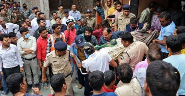 Rescue and security personnel carry an injured devotee on a stretcher after the floor covering a stepwell collapsed at a temple, Indore, India, March 30, 2023. (AFP Photo)