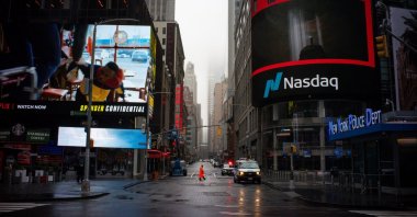 A man walks near Nasdaq MarketSite in an empty Times Square during the coronavirus outbreak in New York City, U.S., March 29, 2020. (Reuters Photo)