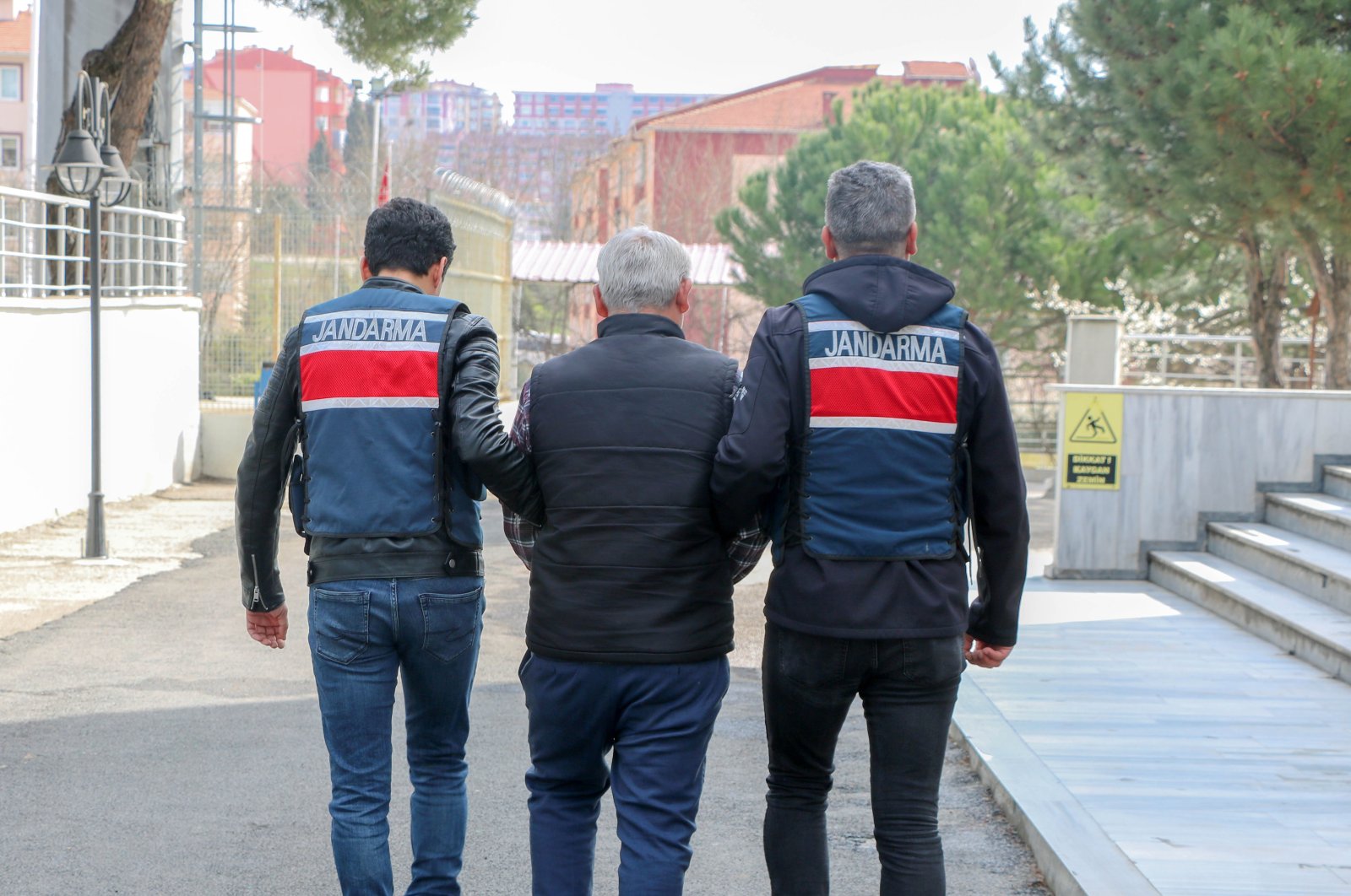 Gendarmerie officers escort one of the five suspects from the Gülenist Terror Group (FETÖ) and the PKK apprehended while trying to cross into Greece from northwestern Edirne province, Türkiye, March 30, 2023. (DHA Photo)