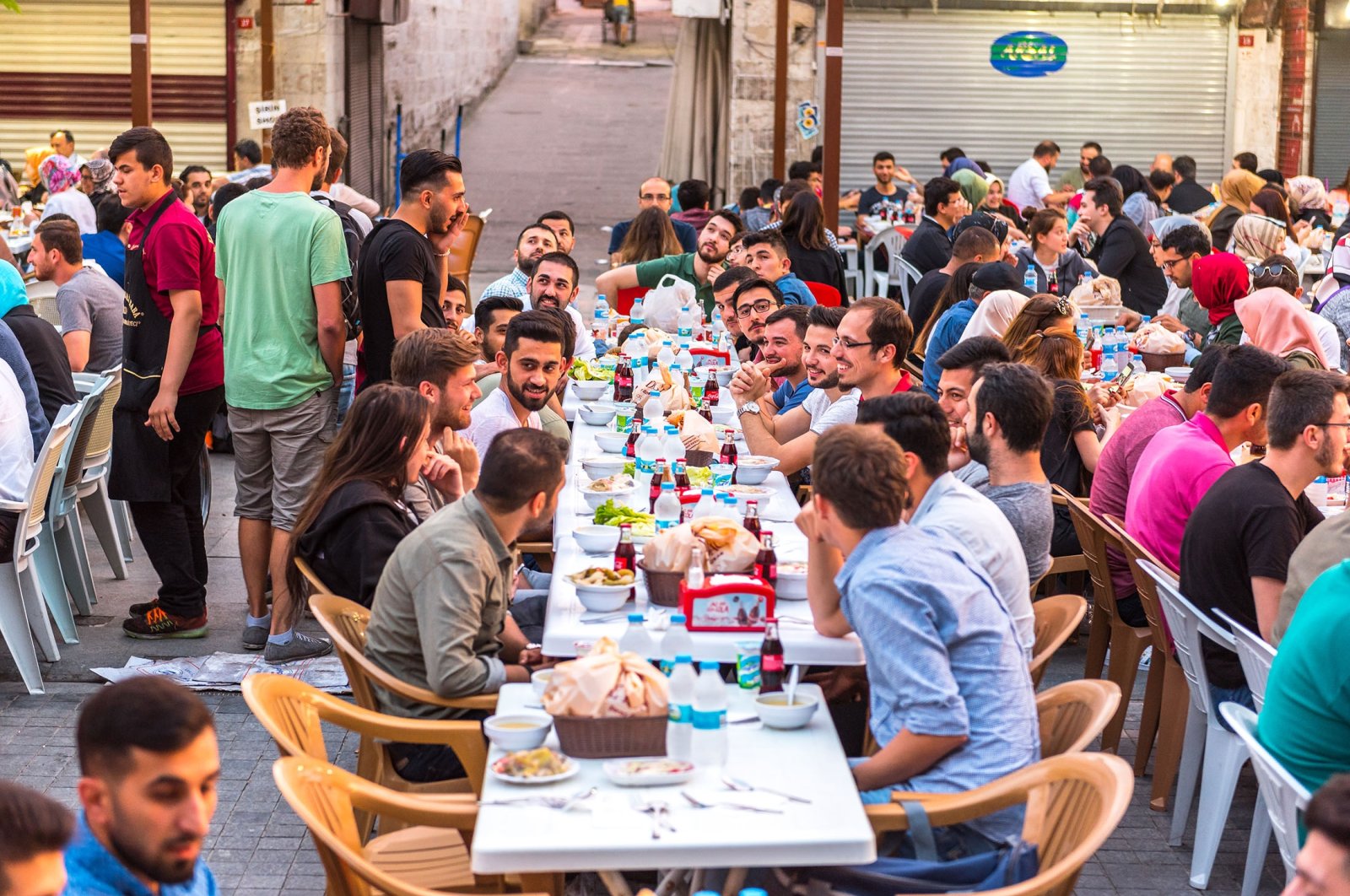 People eat iftar during Ramadan, in Süleymaniye square, in Istanbul, Türkiye, June 4, 2017. (Shutterstock Photo)