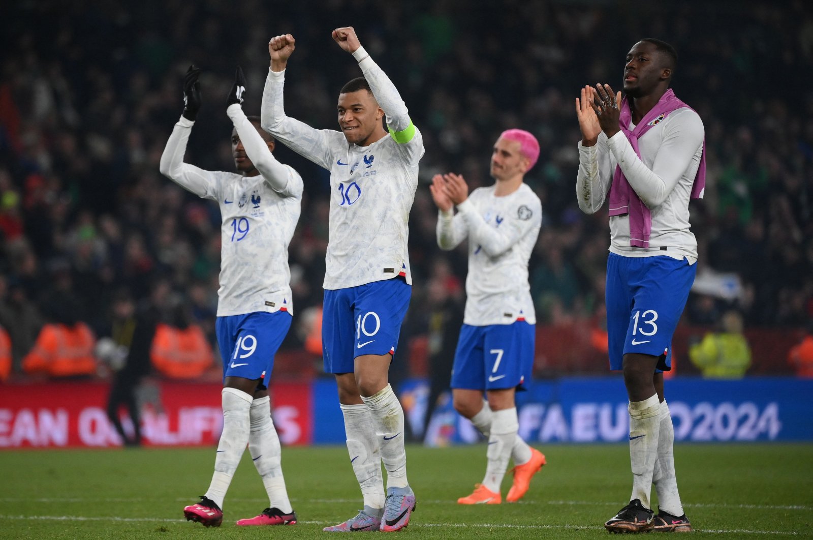 French strikers Kylian Mbappe (2nd L), Moussa Diaby (L) and Antoine Griezmann (2nd R), and defender Ibrahima Konate (R) applaud fans on the final whistle in the UEFA Euro 2024 group B qualification football match between Ireland and France at Aviva Stadium in Dublin, Ireland on March 27, 2023. (AFP Photo)