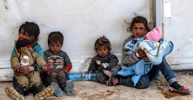 Children sit on the ground at al-Hol Camp, in Hasakeh, Syria, Mar. 18, 2021. (AFP Photo) 
