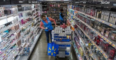 An employee organizes beauty products inside the Walmart Supercenter in North Bergen, N.J. on Thursday, Feb. 9, 2023. A strong job market has helped fuel the inflation pressures that have led the Federal Reserve to keep raising interest rates. (AP Photo/Eduardo Munoz Alvarez)