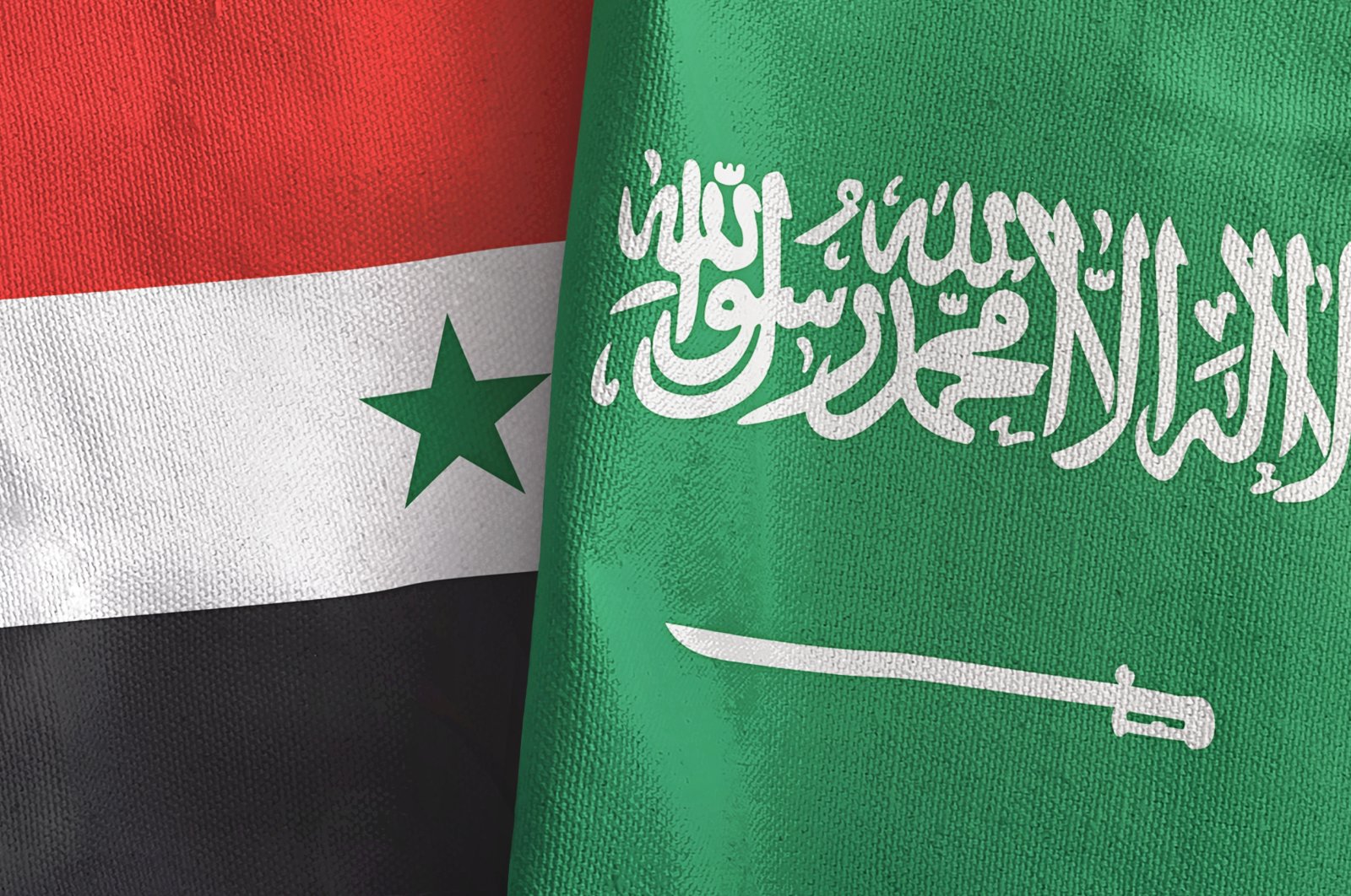This illustration shows Saudi Arabia and Syria&#039;s national flags. (Shutterstock Photo)