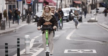 People ride a for-hire e-scooter in Paris, France, April 1, 2023. (EPA Photo)