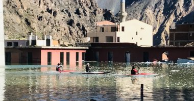 Canoe athletes in Artvin's Yusufeli district train in the dam lake in the old district center, mostly submerged by water from Yusufeli Dam, Artvin, northeastern Türkiye, April 3, 2023. (AA Photo)