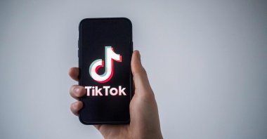 A man shows a smartphone with the logo of Chinese social network TikTok in this file illustration photo taken in Nantes, western France, Jan. 21, 2021. (AFP Photo)