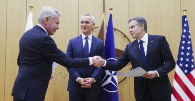Finnish Foreign Minister Pekka Haavisto (L) shakes hands with U.S. Secretary of State Antony Blinken (R) as NATO Secretary-General Jens Stoltenberg (C) stands during a joining ceremony at the NATO foreign ministers&#039; meeting at the Alliance&#039;s headquarters in Brussels, Belgium,  April 4,  2023. (EPA Photo) 