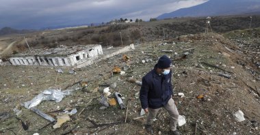 Koen Van Der West, survey manager at Halo Trust mine-clearing organization, examines unexploded items at a damaged ammunition store near Ballıca, in the outskirts of Khankhendi, Karabakh, Azerbaijan, Nov. 23, 2020. (AP File Photo)