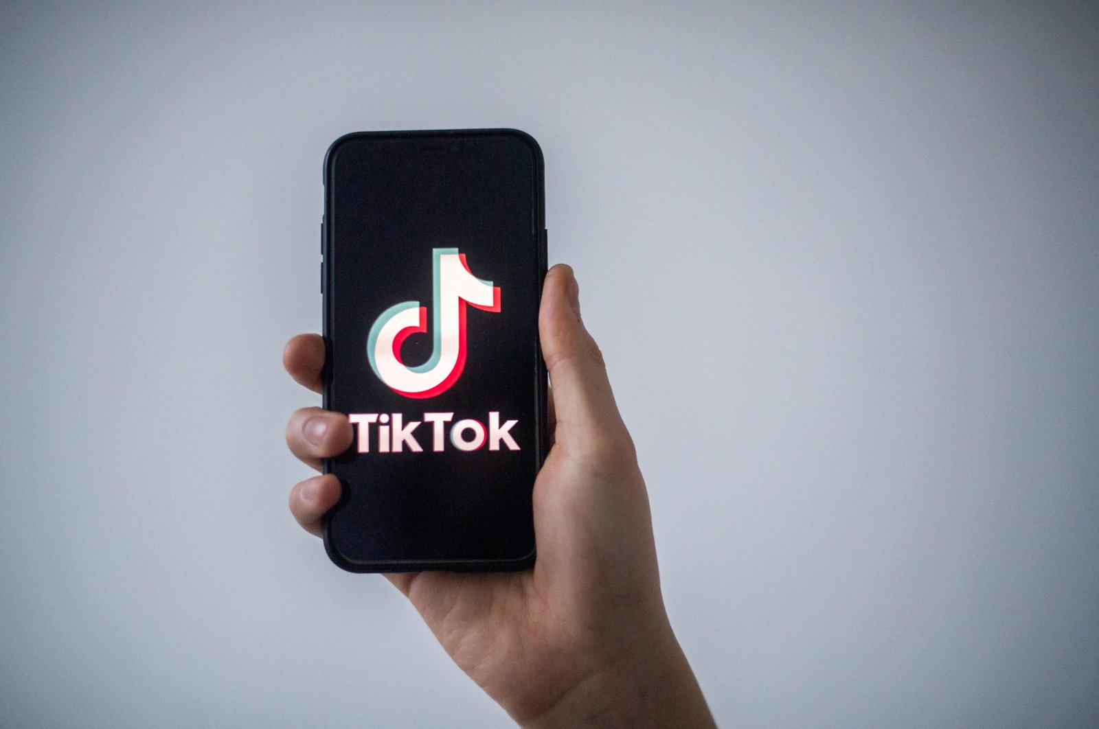 A man shows a smartphone with the logo of Chinese social network TikTok in this file illustration photo taken in Nantes, western France, Jan. 21, 2021. (AFP Photo)