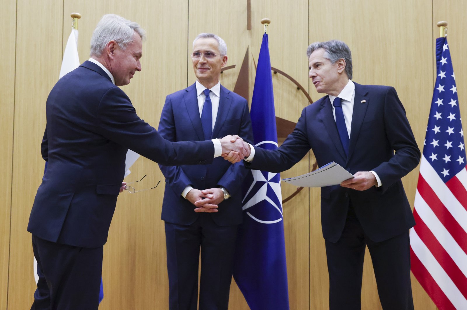 Finnish Foreign Minister Pekka Haavisto (L) shakes hands with U.S. Secretary of State Antony Blinken (R) as NATO Secretary-General Jens Stoltenberg (C) stands during a joining ceremony at the NATO foreign ministers&#039; meeting at the Alliance&#039;s headquarters in Brussels, Belgium,  April 4,  2023. (EPA Photo) 