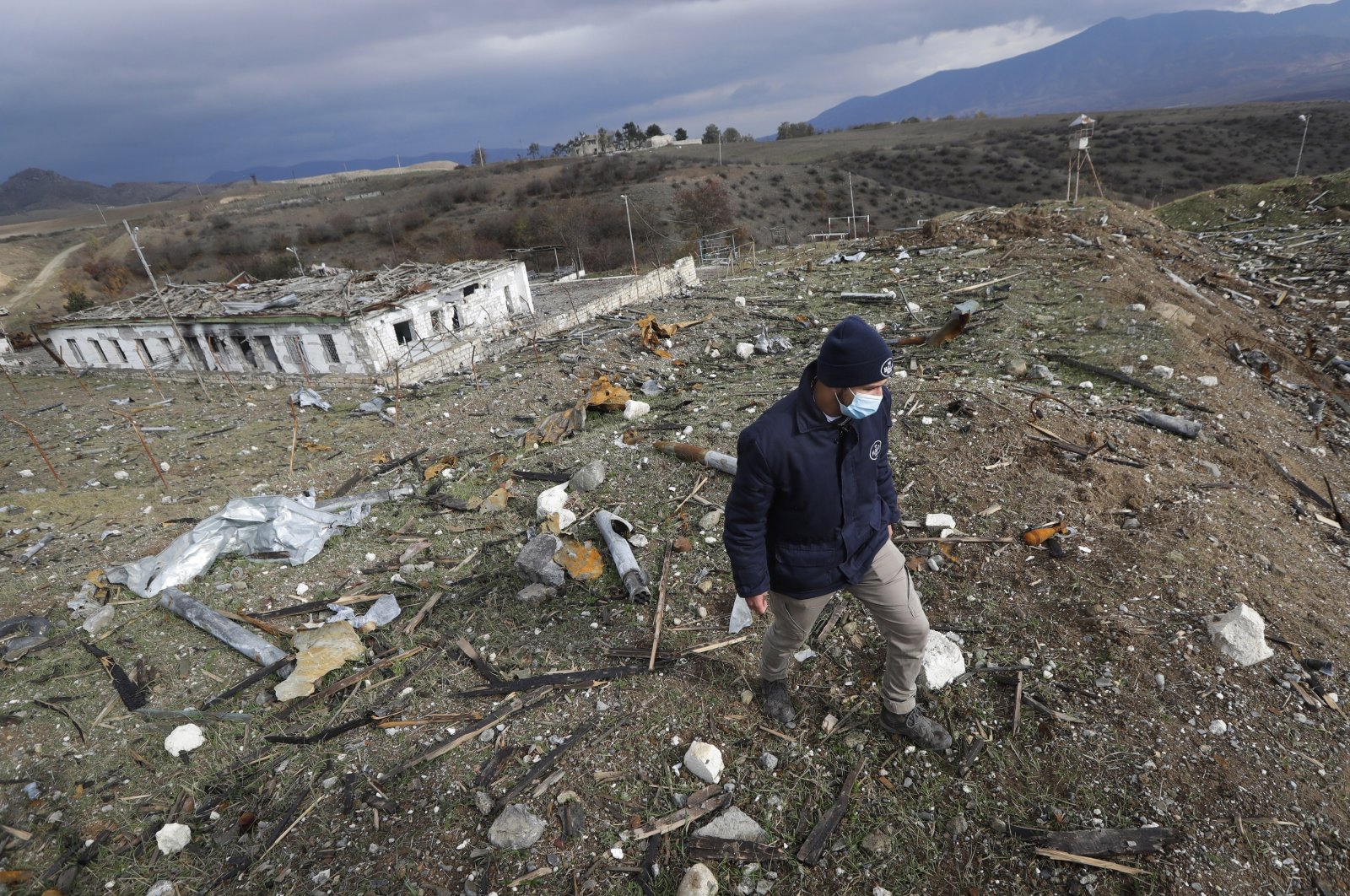 Koen Van Der West, survey manager at Halo Trust mine-clearing organization, examines unexploded items at a damaged ammunition store near Ballıca, in the outskirts of Khankhendi, Karabakh, Azerbaijan, Nov. 23, 2020. (AP File Photo)