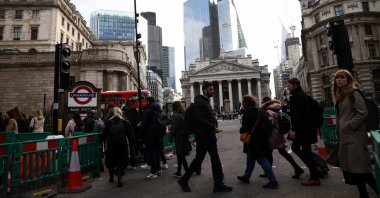 People walk outside the Bank of England (BoE) in the City of London financial district in London, Britain, March 23, 2023. (Reuters Photo)
