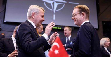 Swedish Foreign Minister Tobias Billström (R) speaks with Finnish Foreign Minister Pekka Haavisto as they arrive to attend a round table during the North Atlantic Council Ministers of Foreign Affairs meeting at the NATO headquarters in Brussels, Belgium, April 5, 2023. (AFP Photo)