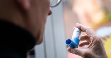 An asthmatic person holds an asthma spray in his hand, in Baden-Wuerttemberg, Sulzburg, Germany, Nov. 7, 2020. (Getty Images Photo)