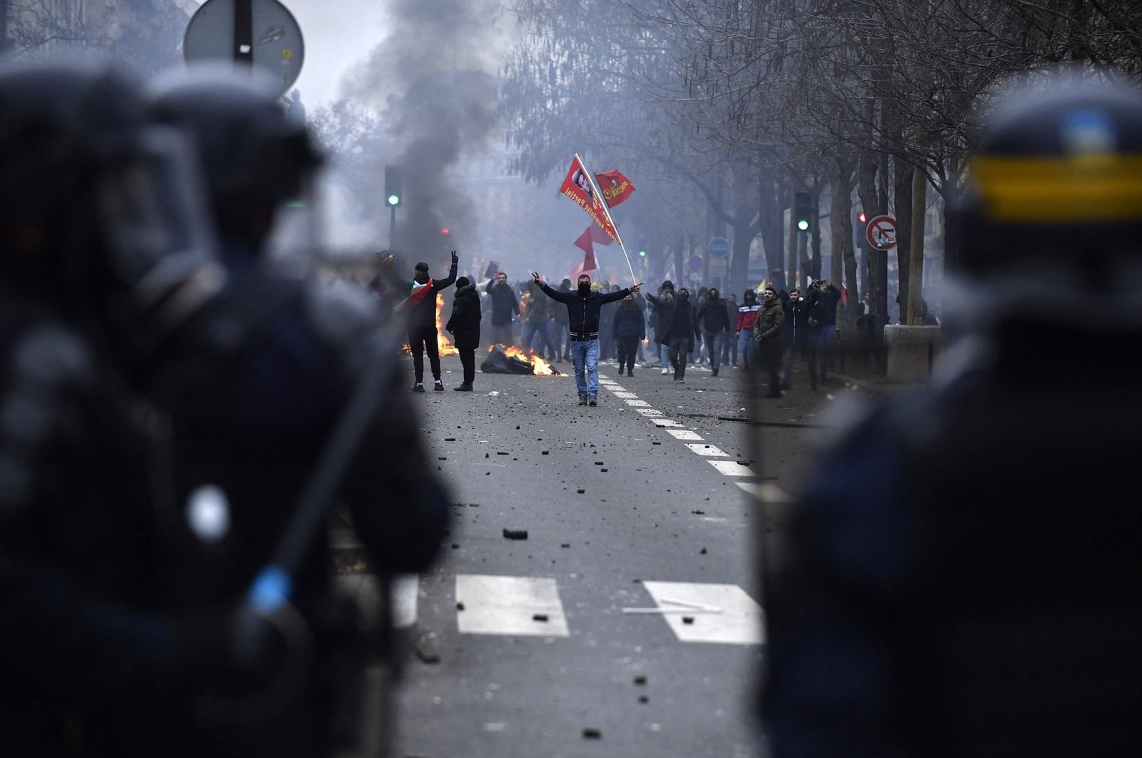 PKK terrorist group supporters face riot police as clashes erupt, at the Place de la Republique, in Paris, France, Dec. 24, 2022. (AFP Photo)