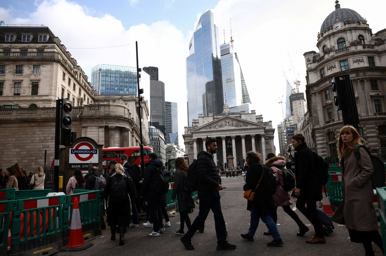 People walk outside the Bank of England (BoE) in the City of London financial district in London, Britain, March 23, 2023. (Reuters Photo)