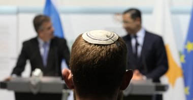 A member of the foreign minister staff attends the Cyprus Foreign Minister Constantinos Kombos (R) and his Israeli counterpart Eli Cohen as they talk to the media during a press conference after their meeting at the Cypriot Foreign Ministry house in capital Nicosia, Cyprus, March 30, 2023. (AP Photo)