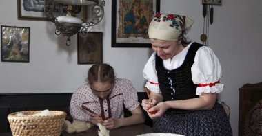 Women in traditional dress decorate Easter eggs, Szentendre, Hungary, April 4, 2010. (Shutterstock Photo)