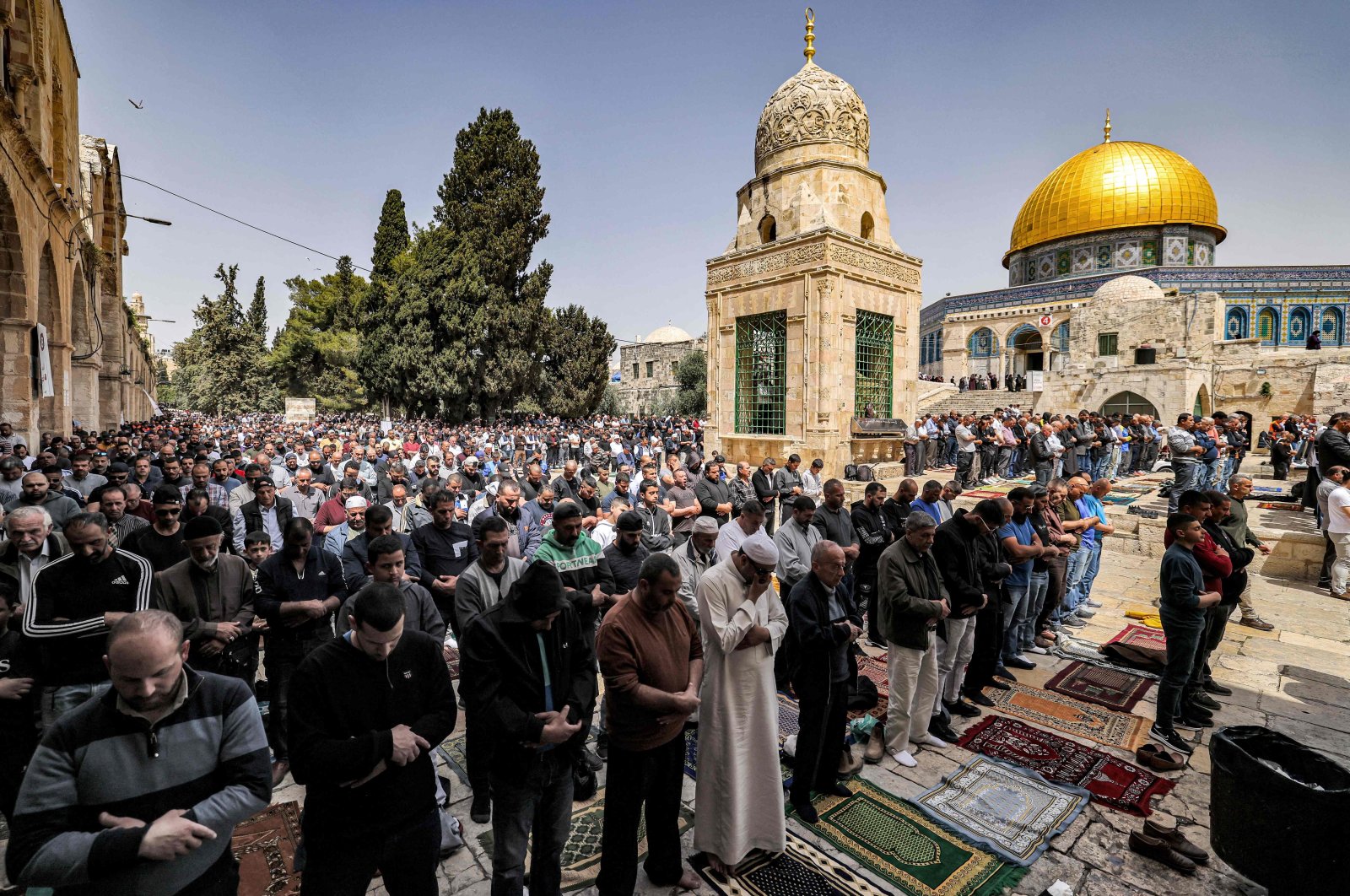Muslim worshippers pray outside the Dome of the Rock shrine at Al-Aqsa Mosque compound in the Old City of Jerusalem on April 7, 2023, on the third Friday Noon prayer during the Muslim holy fasting month of Ramadan. (AFP Photo)