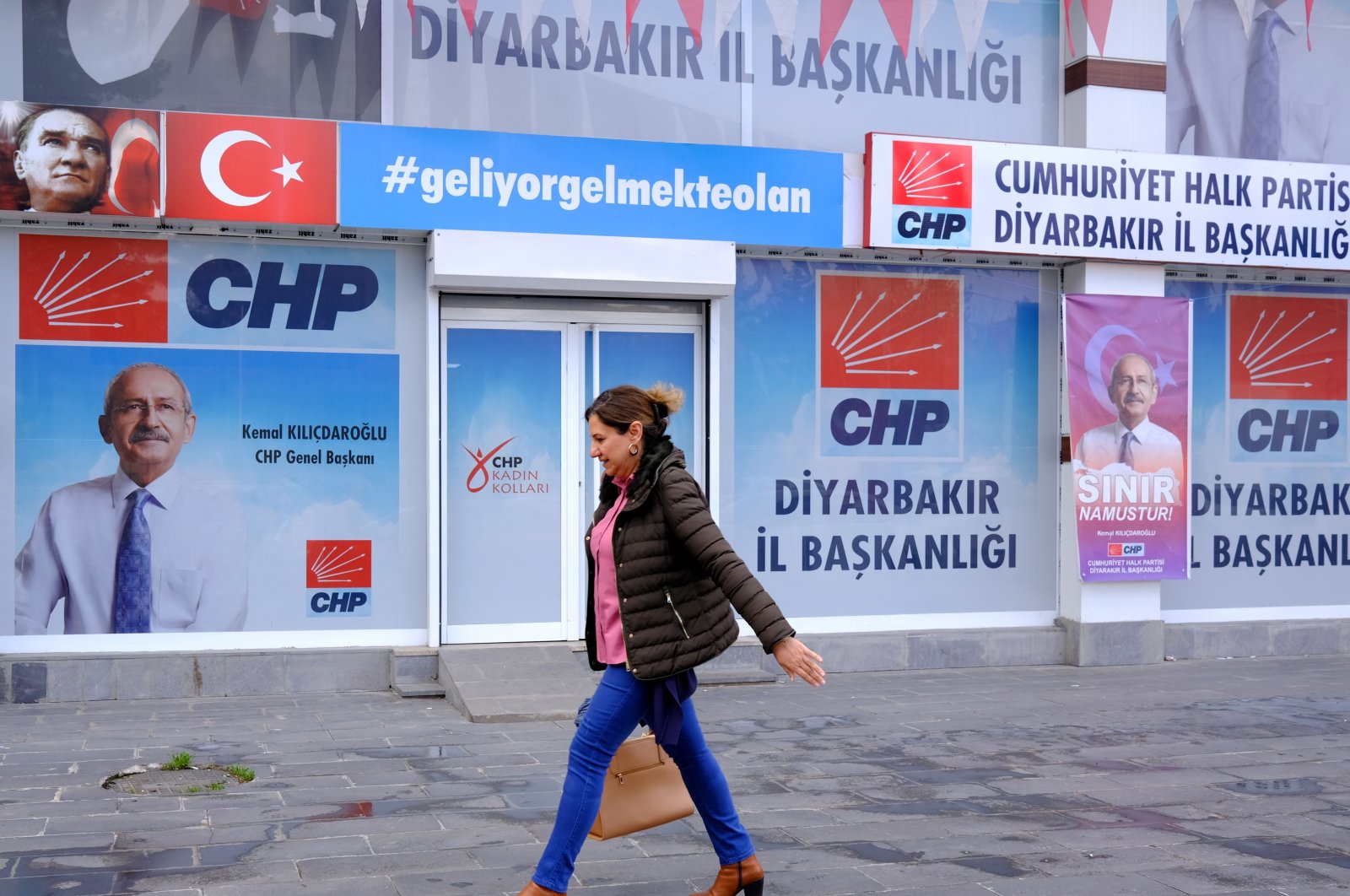 A woman walks past a picture of Republican People’s Party (CHP) leader and presidential candidate Kemal Kılıçdaroğlu in Diyarbakır, Türkiye, March 20, 2023. (EPA Photo)