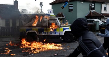 Republicans throw petrol bombs at an armored police car after holding an anti-Good Friday Agreement rally in Londonderry, Northern Ireland, April 10, 2023. (Reuters Photo)
