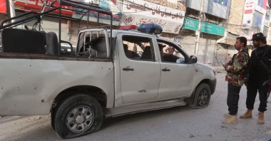 Pakistani security officials inspect a damaged police car at the scene of an earlier blast in Quetta, Pakistan, April 10, 2023. (EPA Photo)
