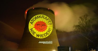 Activists illuminate a cooling tower of the nuclear power plant Emsland with the slogan &quot;Nuclear energy – never again,&quot; in Lingen, Germany, April 10, 2023. (AFP Photo)